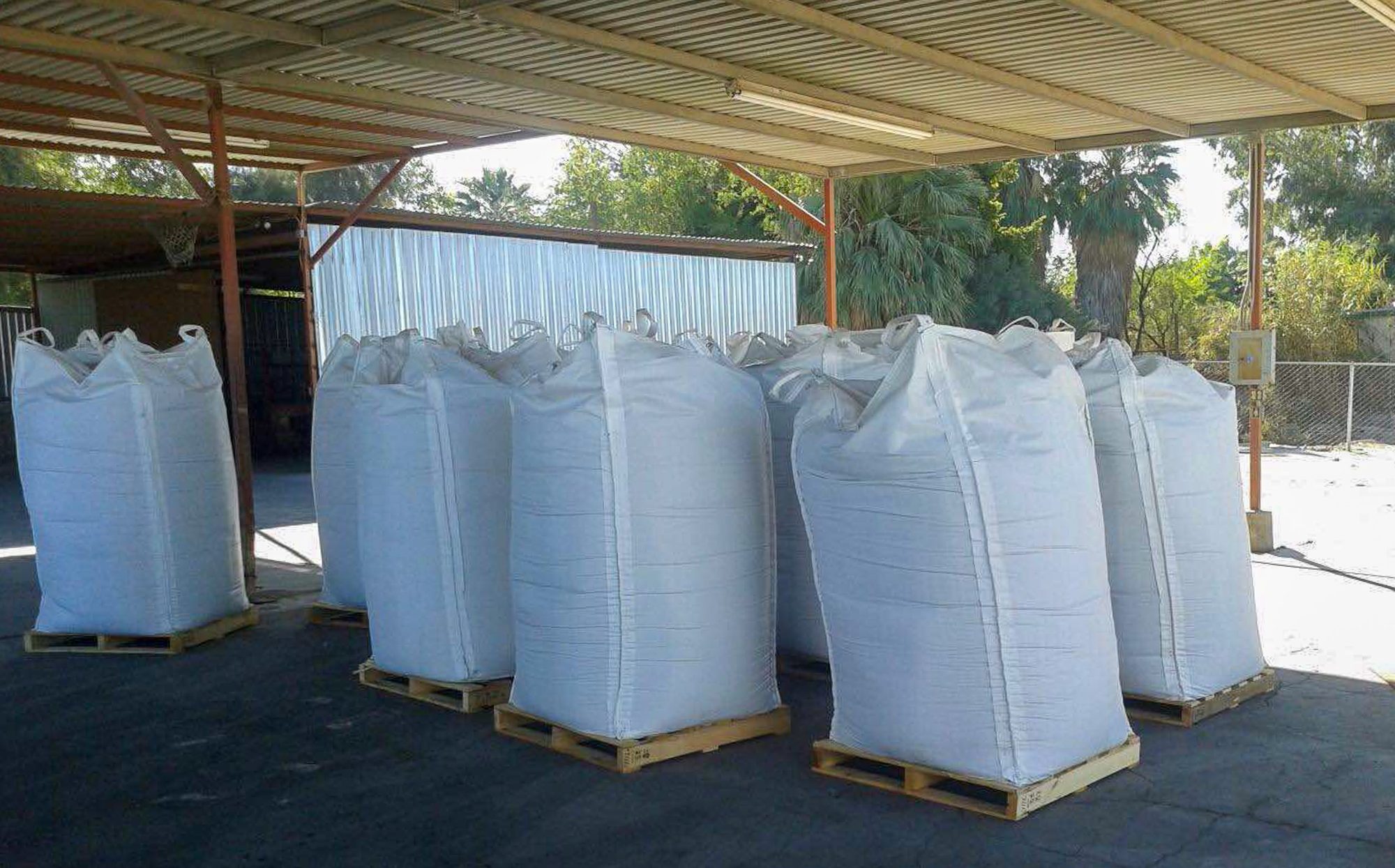 Bulk super sacks of dry organic fertilizer staged for shipment